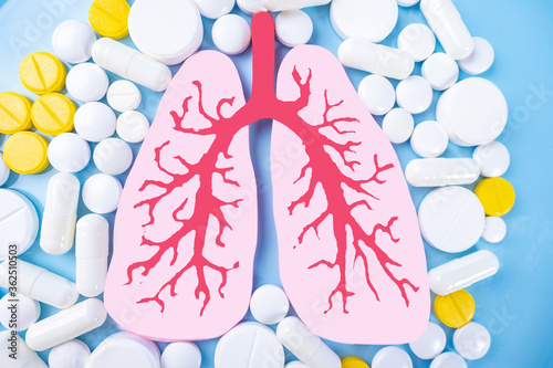 Lungs and tablets on a blue...