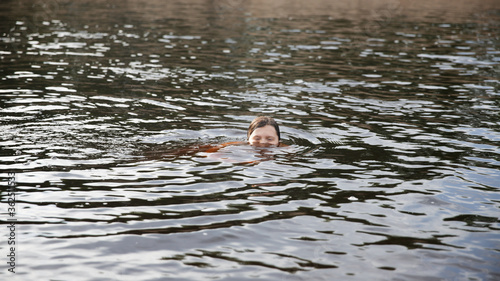 Girl child swims swimming in the river, child safety, the child drowns in water