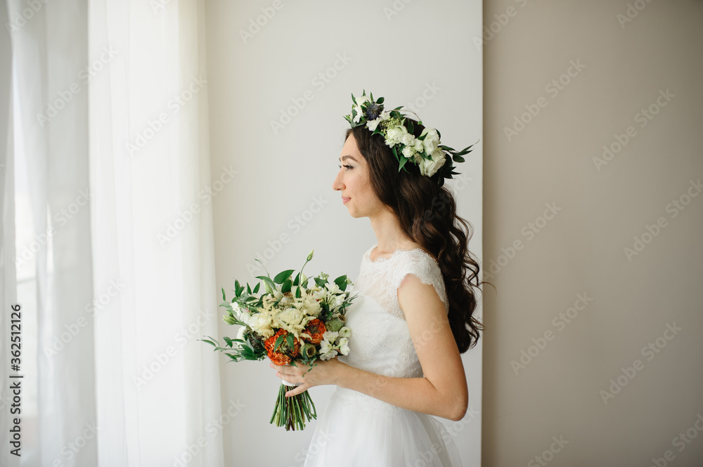 Beautiful bride with a bouquet of flowers and a wreath on her head. Beautiful bride with a bouquet of flowers and a wreath on her head.