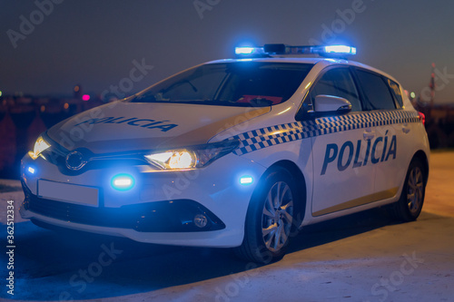 police car with the city in the background