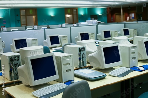 Wide angle shot of a business environment with a myriad of old computers in the room photo