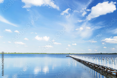 Wallpaper Mural Blue sky with light clouds, blue water and white pier in the sunny summer day. Torontodigital.ca
