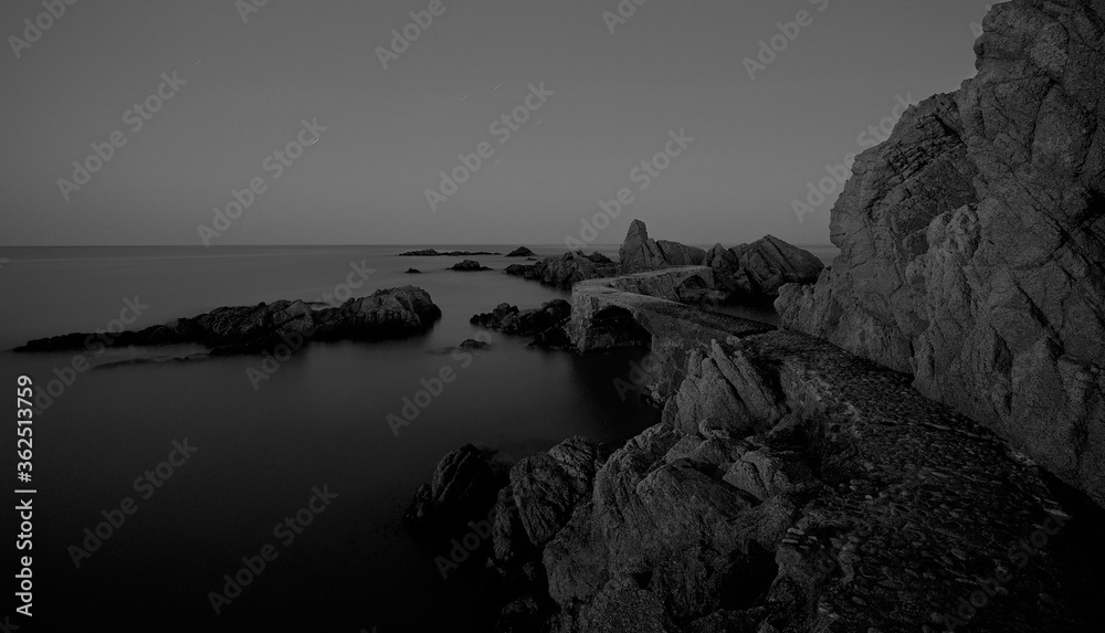 Night landscape on the coast next to the rocks