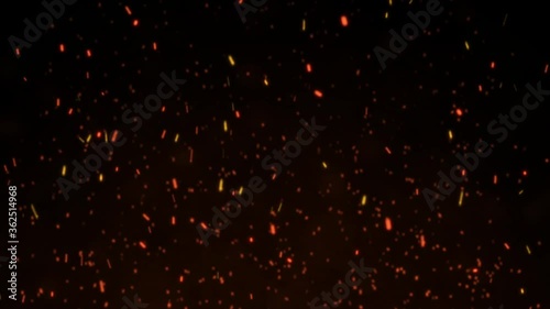 Burning red hot sparks flying from large fire flame on black background.