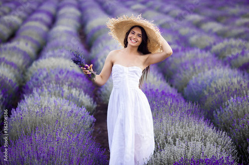 Young beautiful woman in lavender field. Lady on summer background