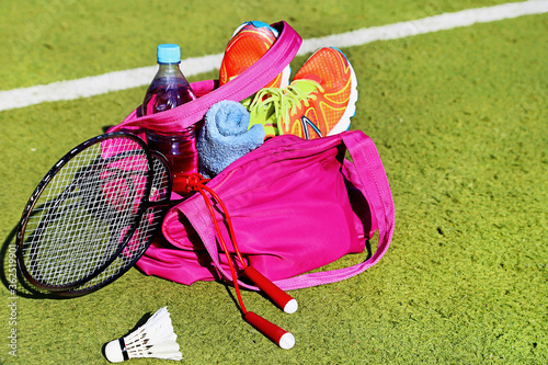 Bag with sports equipment on the sports courts background.