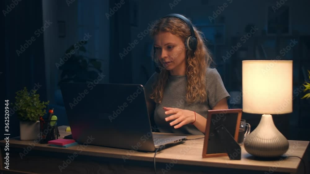 Young woman having an online chat late at night Young woman having an online chat late at night