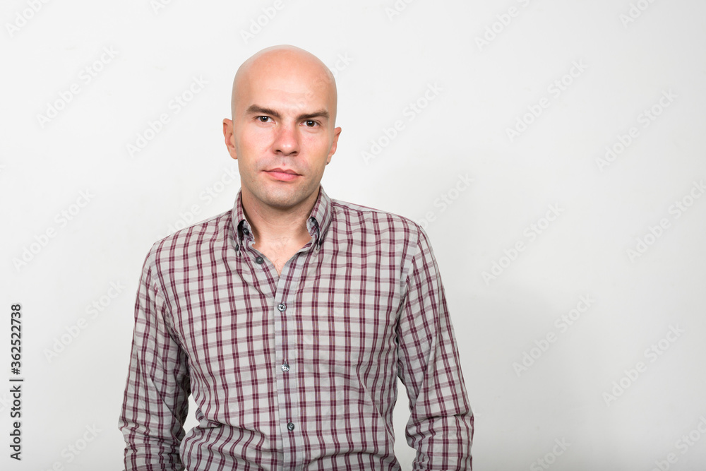 Portrait of bald businessman looking at camera Portrait of bald businessman looking at camera