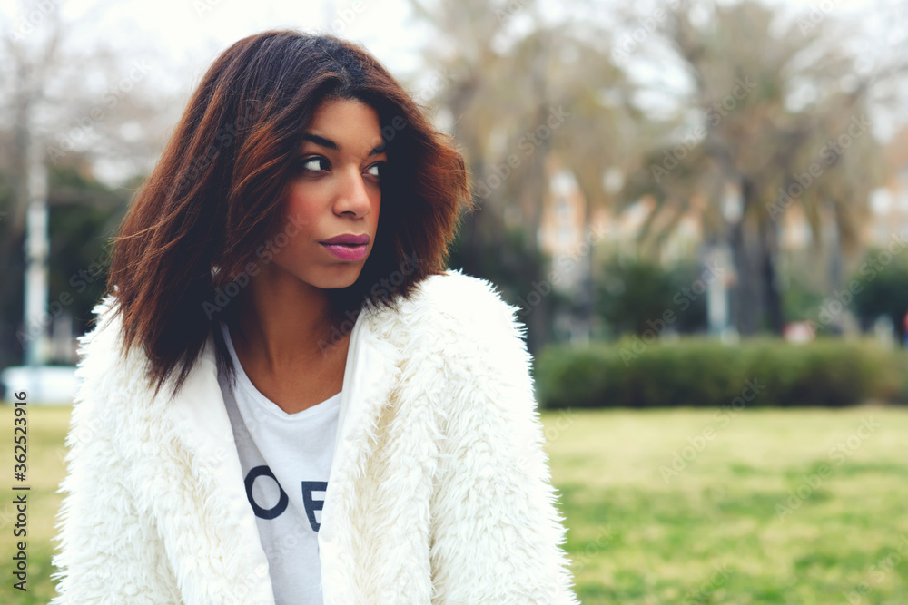 Portrait of attractive afro american woman with brunette hair sitting in the park with copy space for your text message, trendy female hipster in stylish clothing pensive looking away, filter Portrait of attractive afro american woman with brunette hair sitting in the park with copy space for your text message, trendy female hipster in stylish clothing pensive looking away, filter