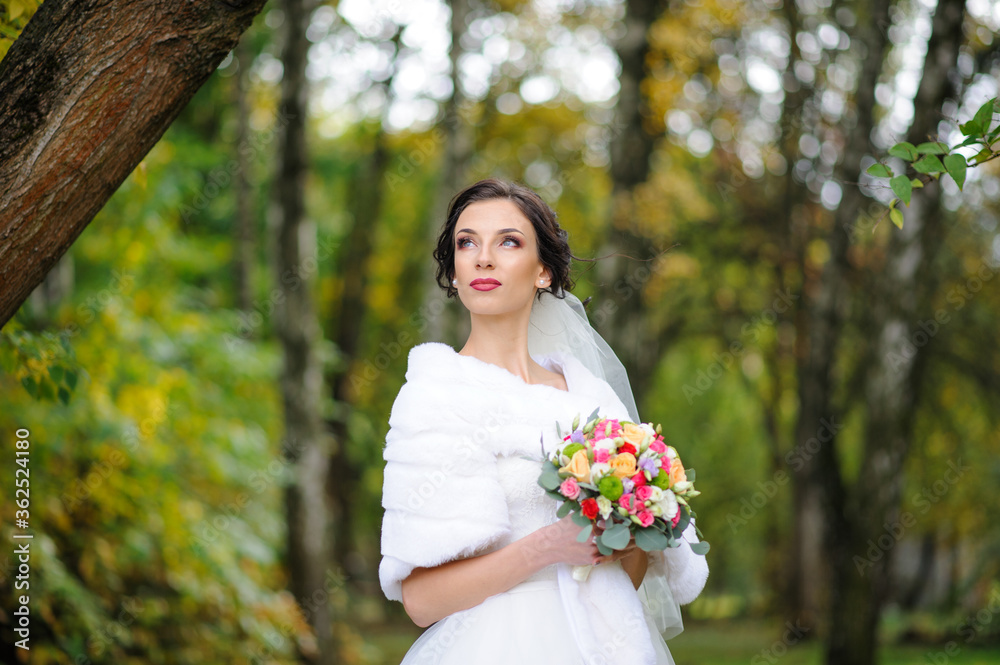 Portrait of a lonely bride on a background of an autumn park. Portrait of a lonely bride on a background of an autumn park.