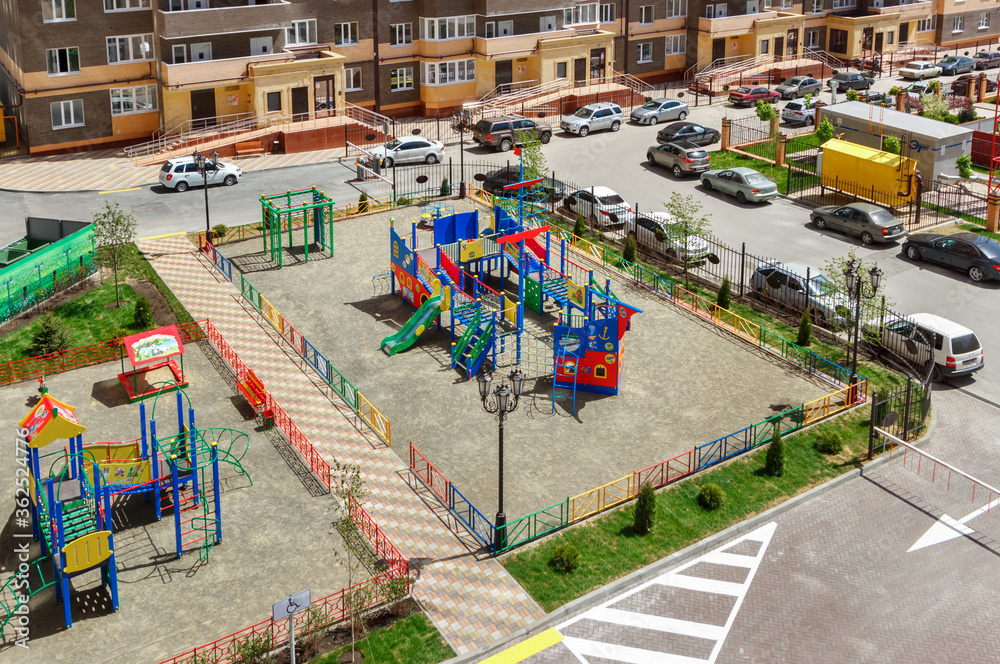 The new modern children's playground in the courtyard of a multistory residential building. Rostov-on-Don / Russia - 07 may 2019