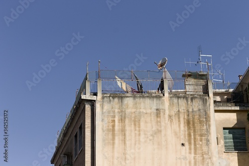 Wallpaper Mural Some antennas and a satellite TV dish on the roof of a house near some clothes hanging on a wire (Pesaro, Italy, Europe) Torontodigital.ca