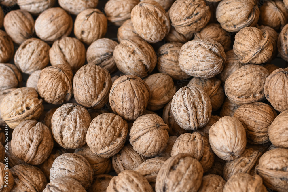 Lots of walnuts top view, texture and background of walnuts, selective focus Lots of walnuts top view, texture and background of walnuts, selective focus