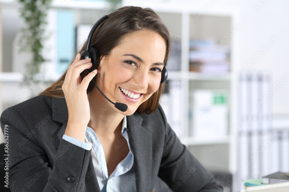 Happy telemarketer posing looking camera at office Happy telemarketer posing looking camera at office