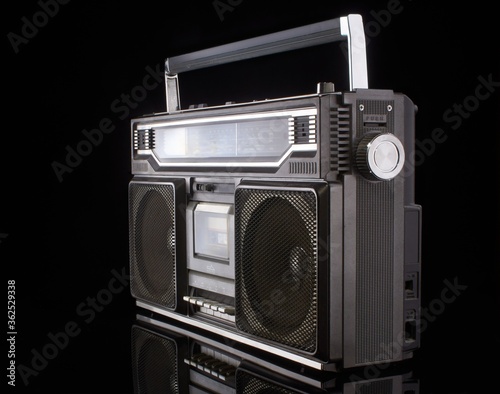 Vintage boom box on black background with reflection