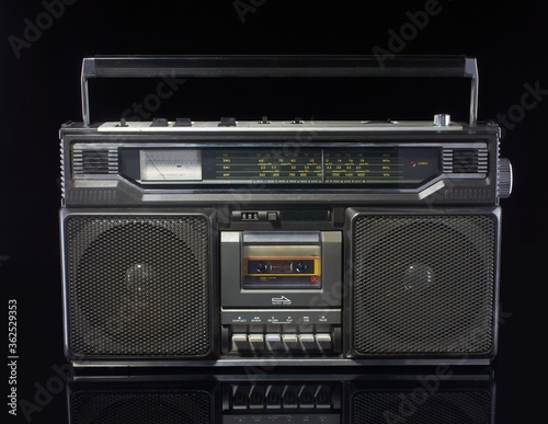 Vintage boom box on black background with reflection