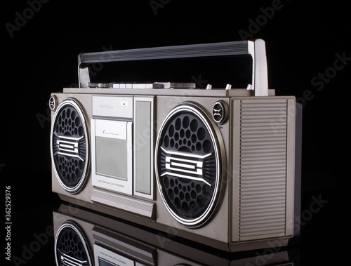 Vintage boom box on black background with reflection