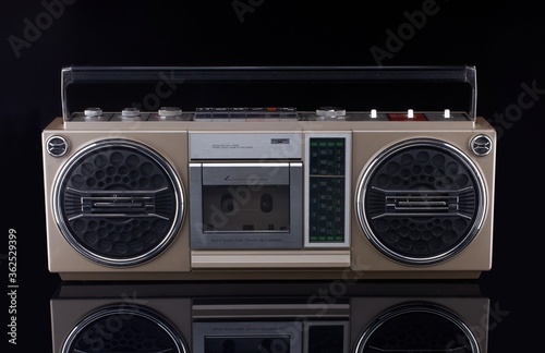Vintage boom box on black background with reflection