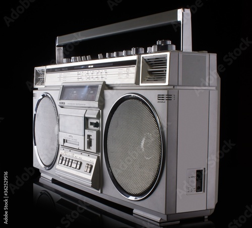 Vintage silver boom box on black background with reflection