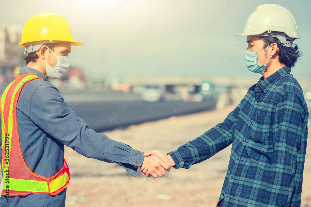 Two engineer shake hand success agreement construction project Two engineer shake hand success agreement construction project