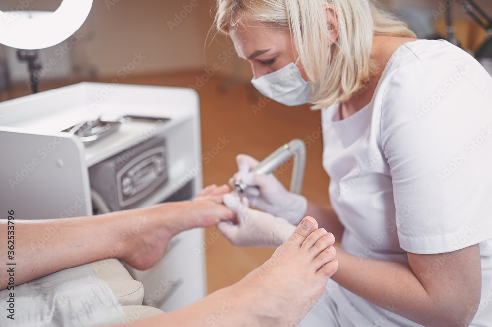 Hardware medical pedicure with nail file drill apparatus. Patient on