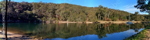 Beautiful panoramic view of Hacking River with reflections of mountains and trees on water, Royal National Park, New South Wales, Australia