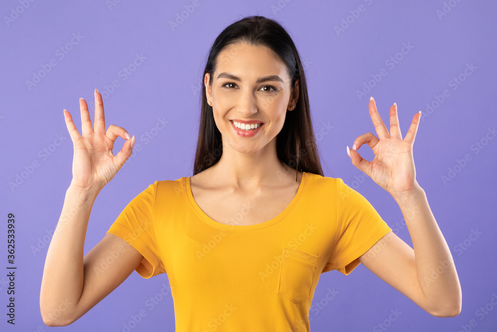 Happy young girl showing ok sign gesture Happy young girl showing ok sign gesture