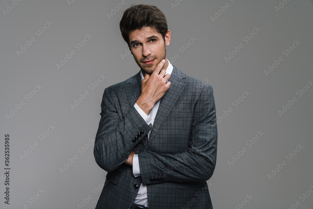 Photo of pleased businessman in jacket posing and smiling at camera Photo of pleased businessman in jacket posing and smiling at camera