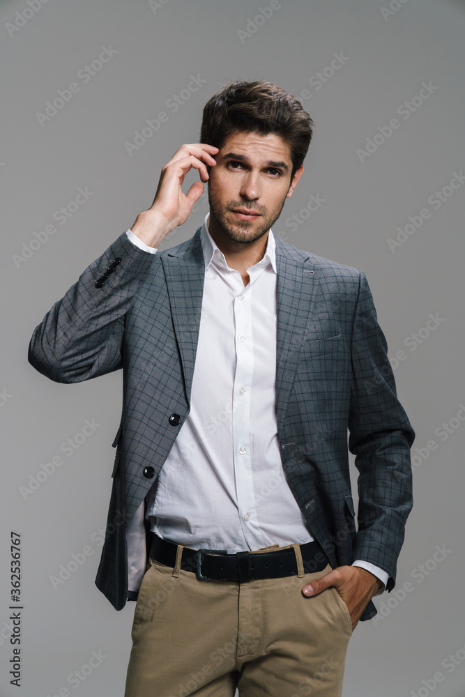 Photo of respectable confident businessman posing and looking at camera