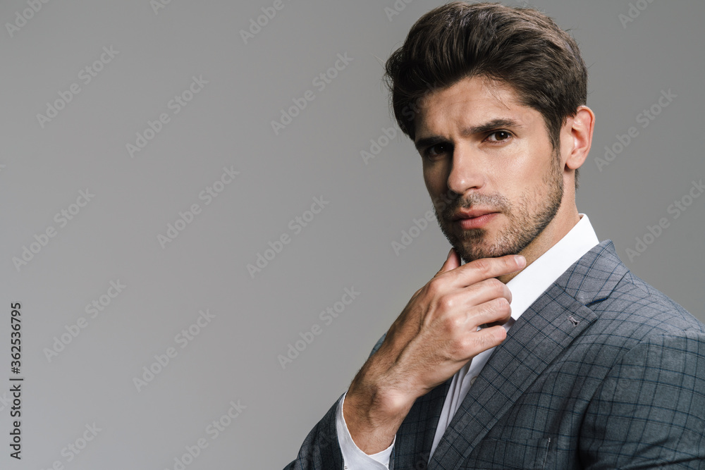 Photo of respectable confident businessman posing and looking at camera Photo of respectable confident businessman posing and looking at camera