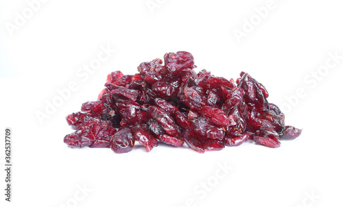 Pile of dried cranberries isolated on white background. Burgundy color fruit  photo