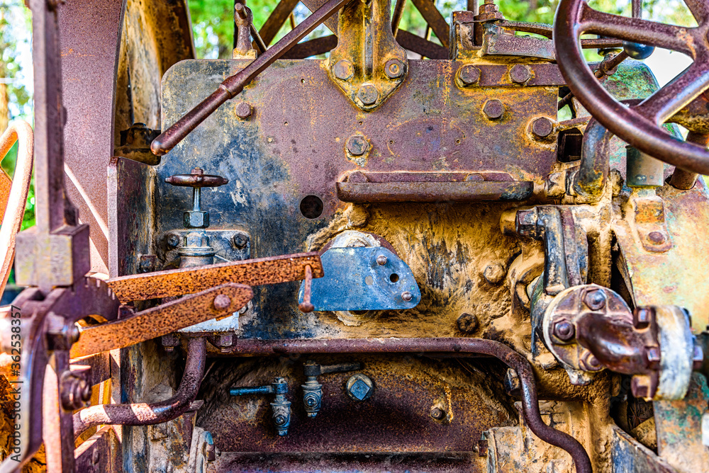 A vintage engine is left outside in the elements to rust and decay.