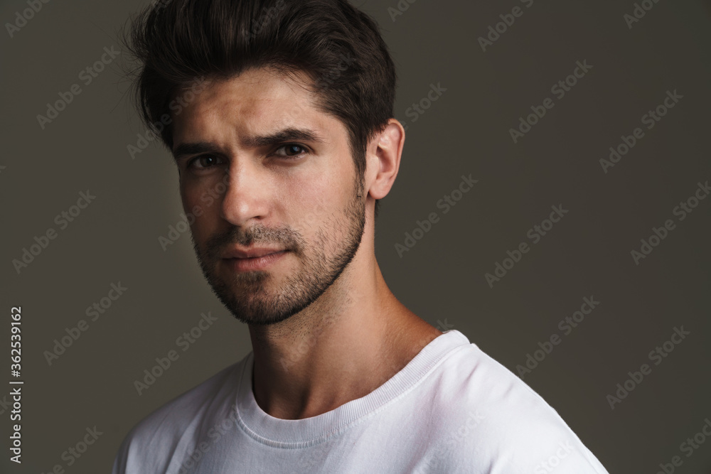 Portrait of brutal young man posing and looking at camera Portrait of brutal young man posing and looking at camera