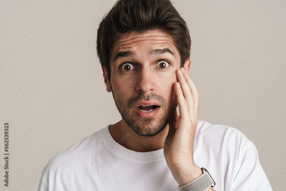 Portrait of shocked young man expressing surprise on camera Portrait of shocked young man expressing surprise on camera