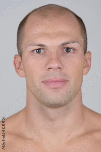 Face of young handsome muscular bald man shirtless