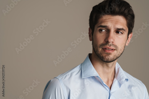 Portrait of unshaven serious man posing and looking aside