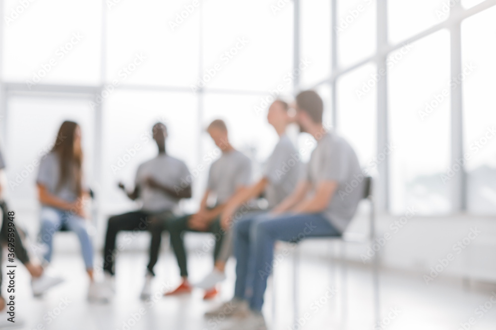 background image of a group of young people at a meeting in a conference room