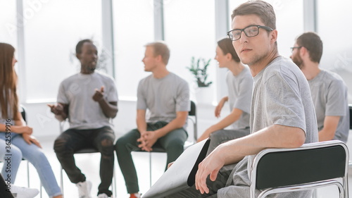 handsome guy sitting in a circle with like-minded person