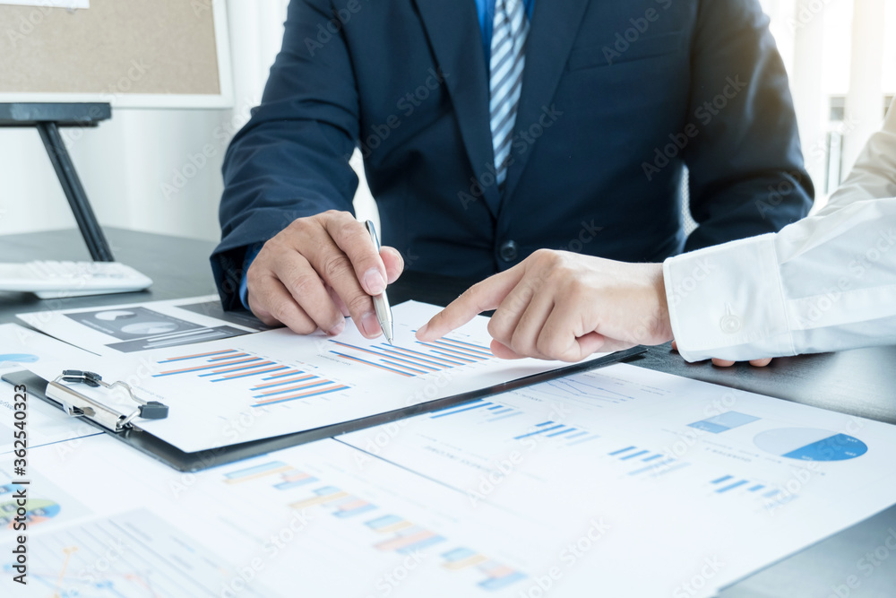 Two business leaders talk about charts, financial graphs showing results are analyzing and calculating planning strategies, business success building processes Two business leaders talk about charts, financial graphs showing results are analyzing and calculating planning strategies, business success building processes