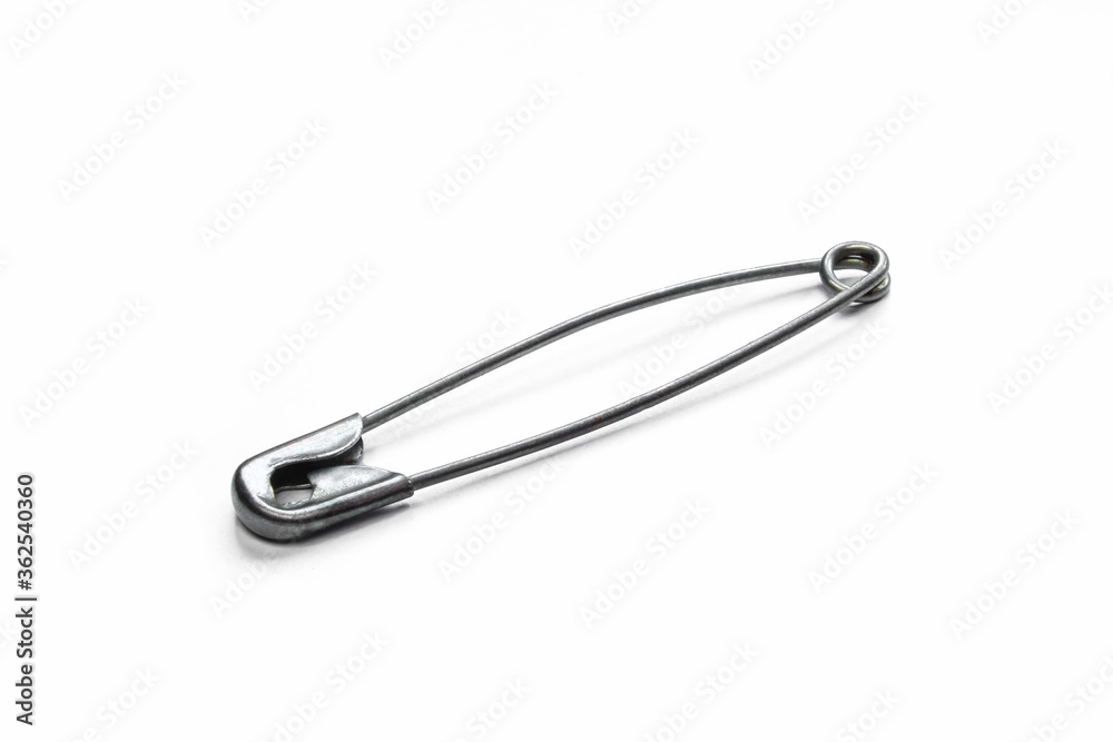 Grey metallic safety pin isolated on white background. Closed single needle pin Grey metallic safety pin isolated on white background. Closed single needle pin