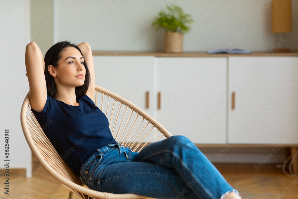Relaxed Woman Sitting Holding Hands Behind Head In Chair Indoor Relaxed Woman Sitting Holding Hands Behind Head In Chair Indoor