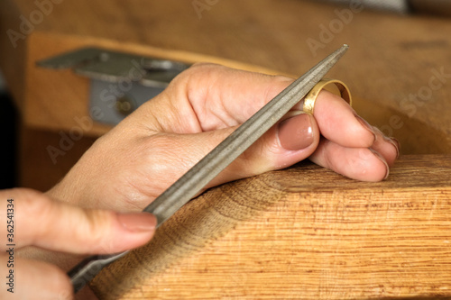 Goldsmiths tools on the jewelry workplace. Tools over rustic wooden background.