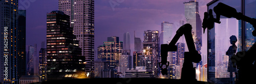 Silhouette of modern automation robot arms with Ai assistant technology network concept and metropolis city building background.