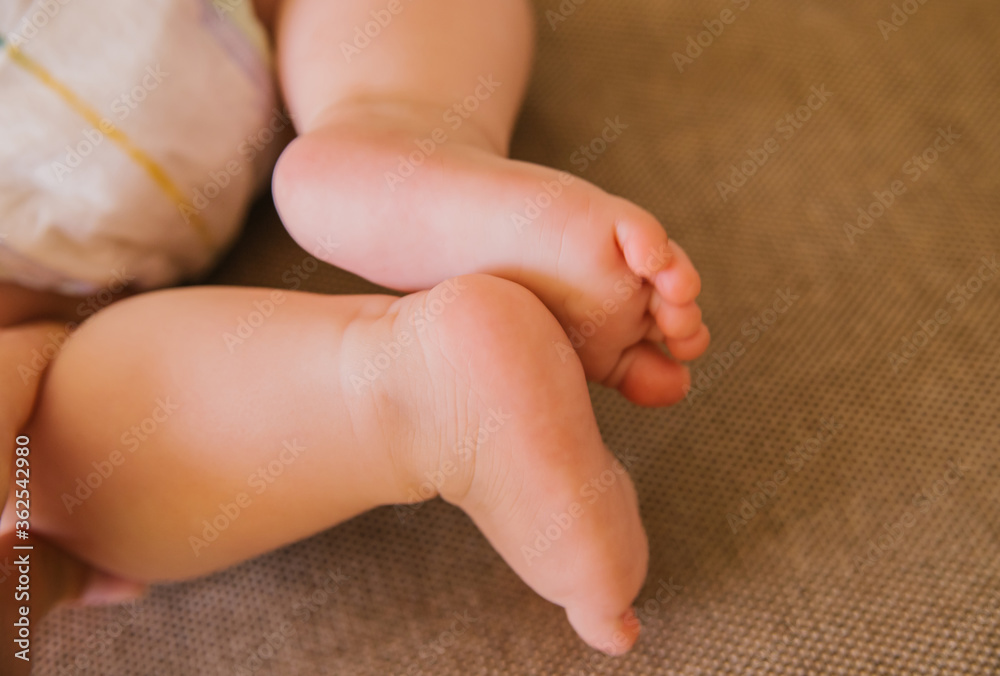 Children's feet peek out from under the blanket. Two children of different ages. Children's feet peek out from under the blanket. Two children of different ages.