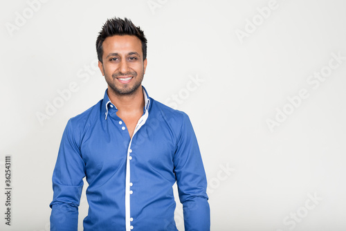 Portrait of happy bearded Indian businessman smiling photo