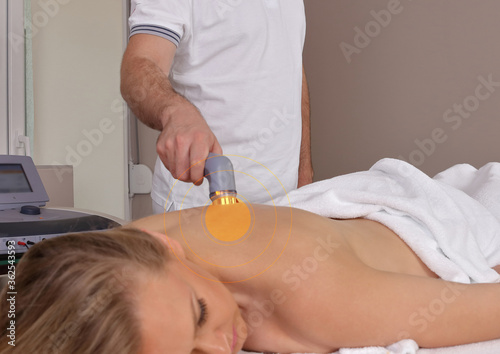 Ultrasound therapy , Electrotherapy, Back pain relief .Physiotherapist and female patient photo