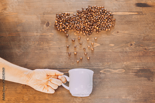 Rain of coffee beans in a white cup