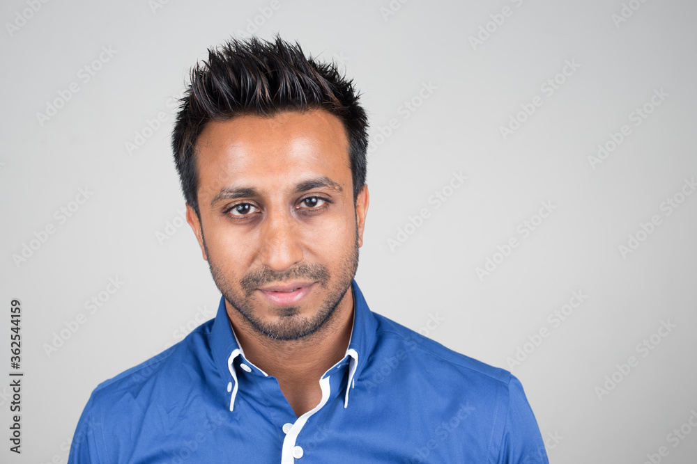 Face of bearded Indian businessman looking at camera Face of bearded Indian businessman looking at camera