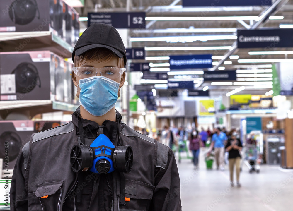 Male mannequin in work clothes with a protective medical mask on his face. Male mannequin in work clothes with a protective medical mask on his face.