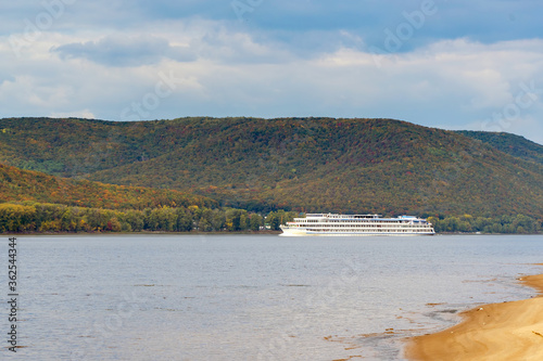A passenger cruise ship sails on the Volga river near the Zhiguli mountains